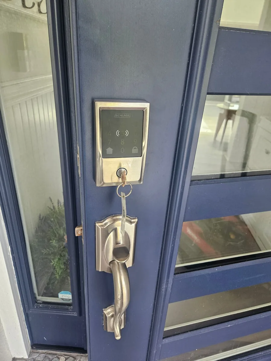 Schlage keypad smart deadbolt and matching handleset fitted on a navy blue front door